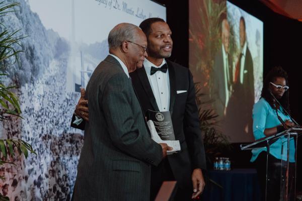 Adjunct Professor Emeritus Clarence Williams (left) was a former assistant to three MIT presidents and former director of the Office of Minority Education; taught in the Department of Urban Studies and Planning; initiated the MIT Black History Project; and mentored hundreds of students. MIT Vice President for Equity and Inclusion Karl Reid (right) was one of those students, and he recognized Williams for his service to the Institute.