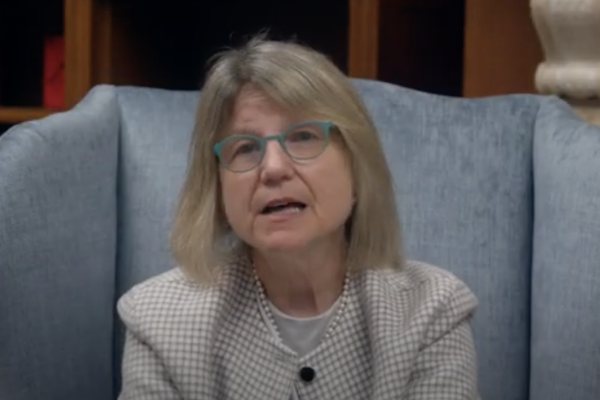 MIT President Sally Kornbluth sits in a blue upholstered chair as she speaks to the MIT community.