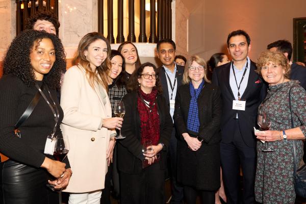 President Kornbluth stands front and center gathered with MIT Alumni and friends in London at the MIT Presidential Welcome Event.