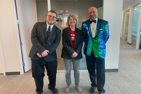 President Kornbluth stands in the center of Nick LeRoy and Kenneth Hewitt celebrating Pi Day.